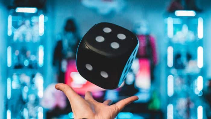 Cité Internationale du Jeu 1 person's left palm about to catch black dice