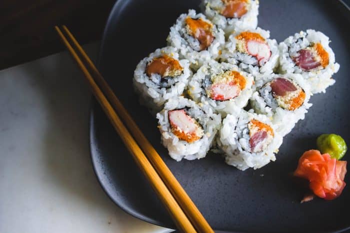 sushi food with brown wooden chopsticks