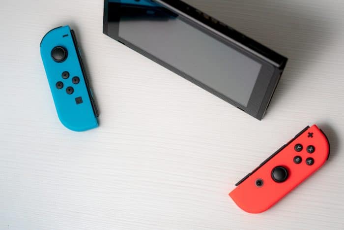 blue nintendo switch beside black tablet computer