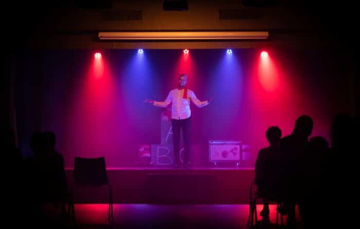 Mercredis Comedy Show 1 man in black shirt singing on stage