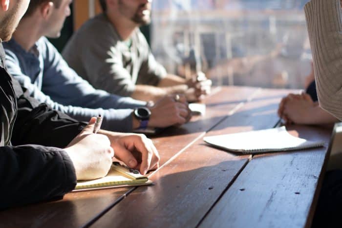 Quiz Blind test 1 people sitting on chair in front of table while holding pens during daytime