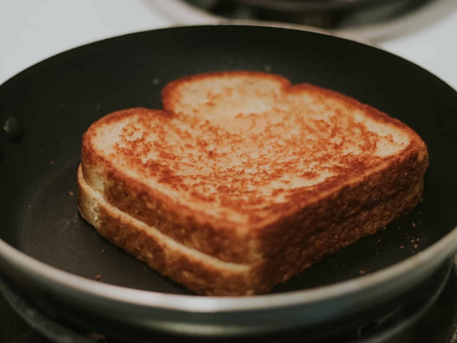 a toasted sandwich in a frying pan on a stove
